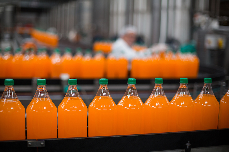 Bottle of juice processing on production line in bottle factory